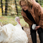 Joyce Tischler and her new turkey friend, Belle, at Wildwood Farm Sanctuary