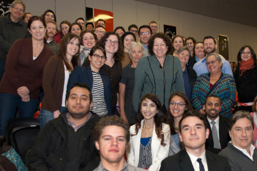 U.S. Supreme Court Justice Sonia Sotomayor pauses for a photo amid members of the audience.