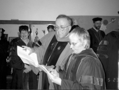Professor Doug Newell and Associate Dean Martha Spence '83 compare notes before the 1998 commencement ceremony.