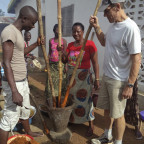Professor Dan Rohlf pounding palm oil seeds in Sierra Leone.