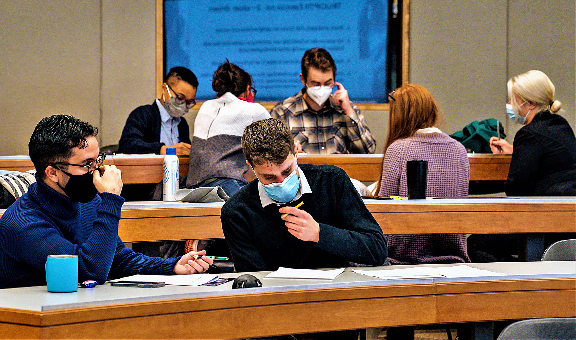 Students work in groups, devising beneficial solutions to the hypothetical legal challenge.