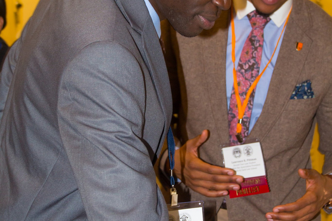 SBA President Lawrence Pittman '18, talks to a potential new student at a recruiting event