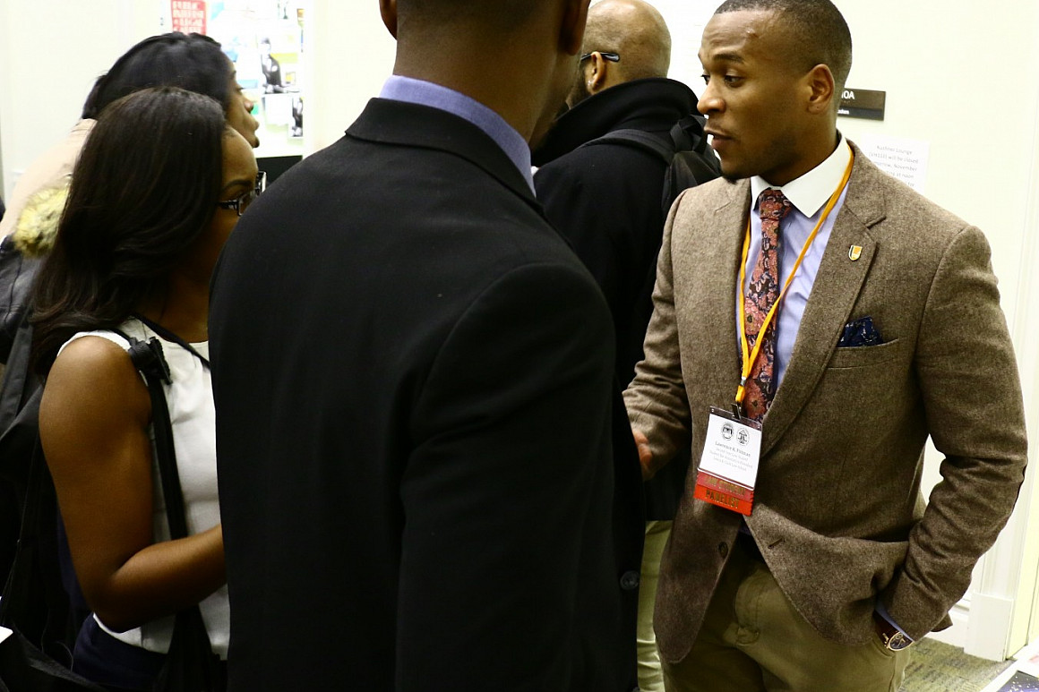 SBA President Lawrence Pittman '18, talks to potential students at a recruiting event