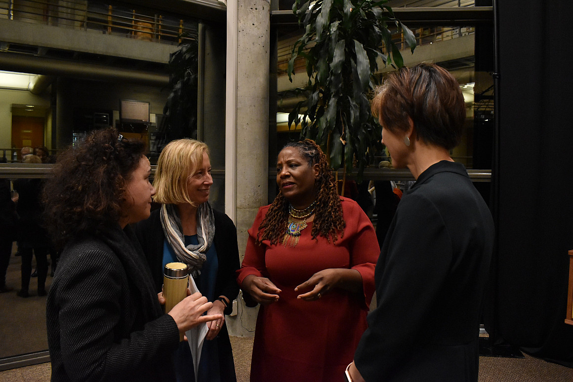 Michelle DePass meets after the lecture with environmental and climate change professors, Lisa Benjamin, Janice Weis and Lucy Brehm.