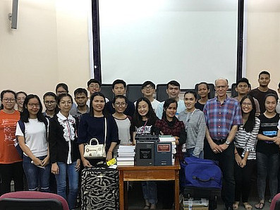 Professor Klonoff with 240 pounds of donated law casebooks, and his Cambodian students.