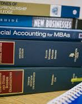 Stack of MBA and law textbooks.