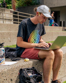 Lewis & Clark Law School student working on a laptop in the amphitheater.