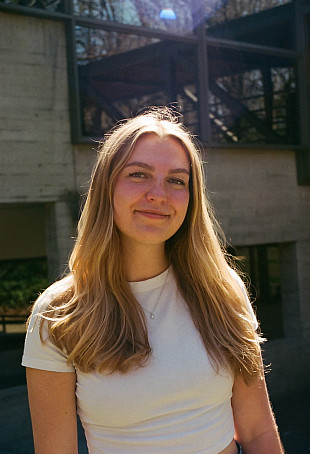 Jessica smiling at the camera, wearing a white top.