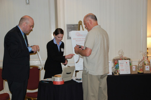 Conference volunteers help sell raffle tickets for NCVLI's Crime Victims' Rights Reception. - Photo by Susan Bexton