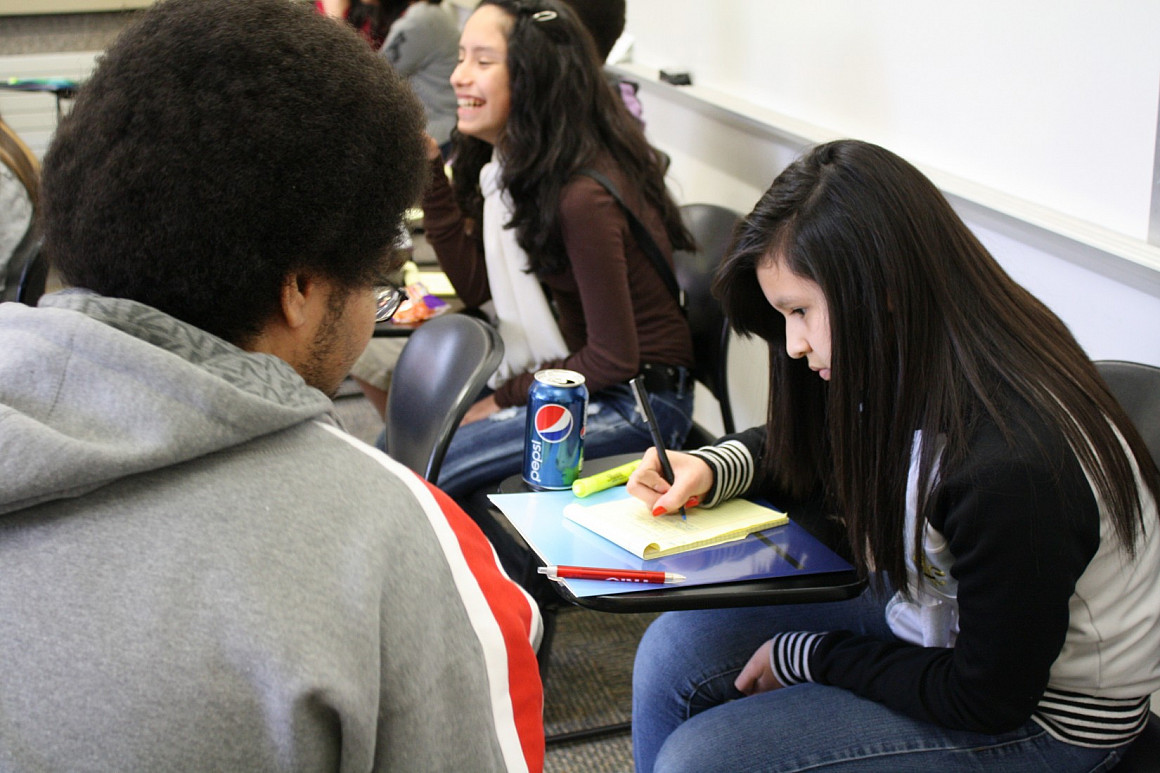 1L Charles Malmsten assisting a student with her cross examination.