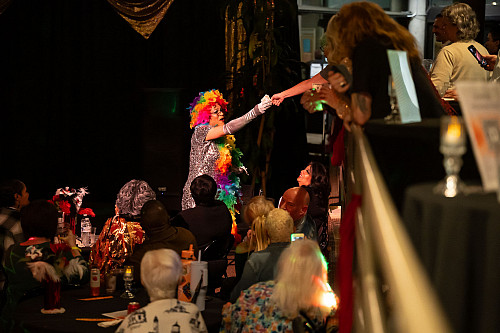 Regina reaches for a donation from the crowd.