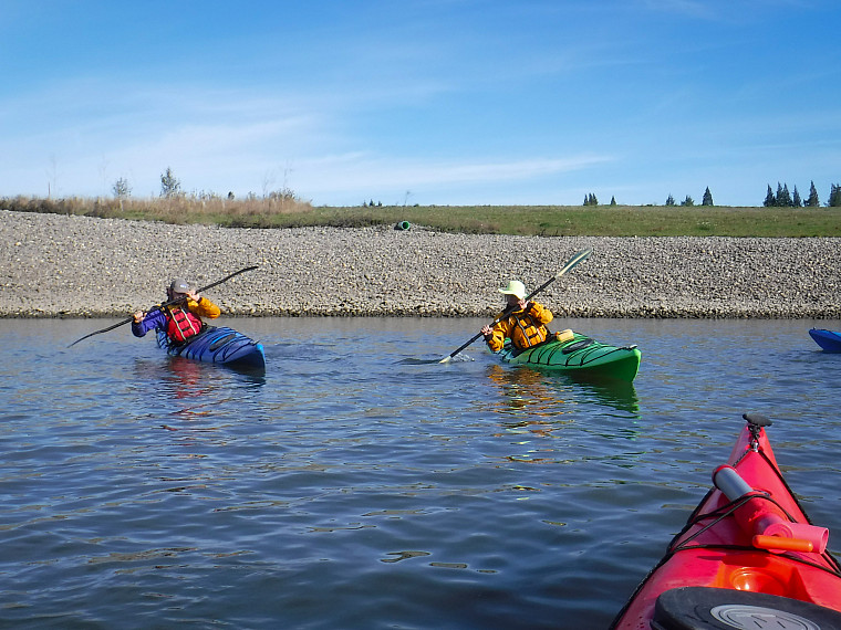 Two kayakers practice maneuvers