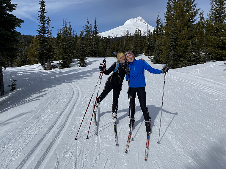 Madeline Swanberg and Gillian Luegers pose during a skate ski trip in front of Mt. Hood.