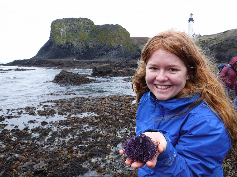 A student holds a sea urchin found tidepooling at the Oregon coast
