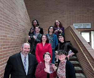 The L&C team and coaches on a staircase