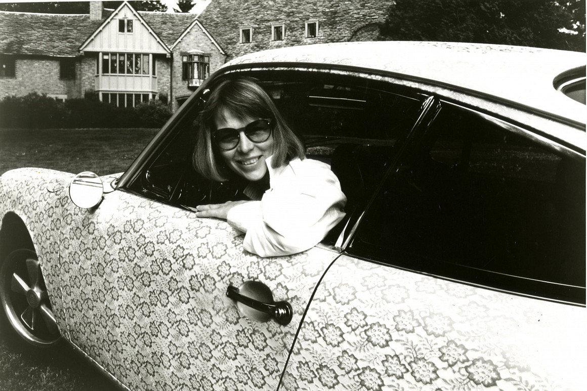 Phyllis Yes pictured in her lace Porsche parked outside of Frank Manor at Lewis & Clark College.