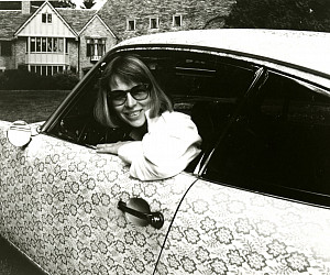 Phyllis Yes pictured in her lace Porsche parked outside of Frank Manor at Lewis & Clark College.