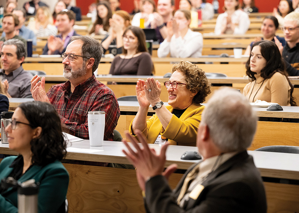 Professor Joyce Tischler joins the crowd in enthusiastically responding to Kristof's keynote address.