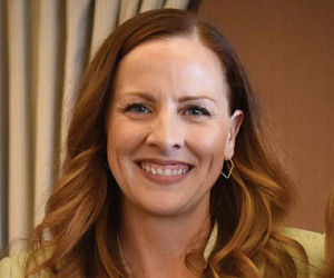 Ambyr O'Donnell '01 (center) poses with Dean Jennifer Johnson, President Wim Wiewel, and son Ashton Vasquez.