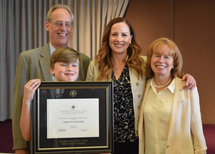 Ambyr O'Donnell ?01 (center) poses with Dean Jennifer Johnson, President Wim Wiewel, and son Asht...