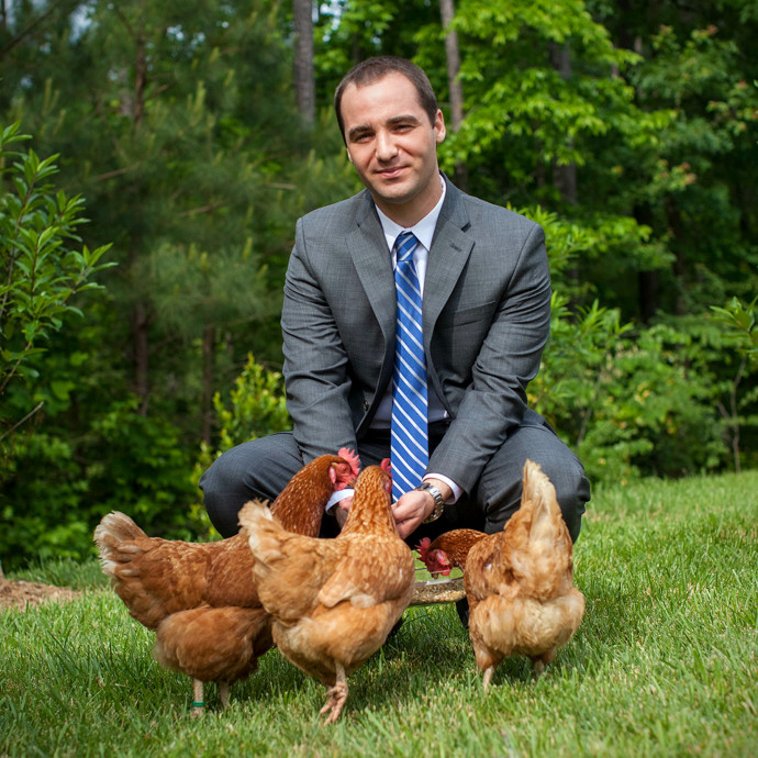 Matt spending time with three spent hens rescued from an egg factory farm in North Carolina.