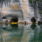A canoer exploring the Buffalo National River and the unique karst geology of the area.