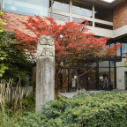 Exterior entrance of Aubrey R. Watzek Library featuring a concrete cast of an owl carving made by Chief Don Lelooska (1933–96) of the C...