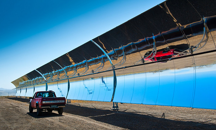 March 26, 2012 - NREL engineers Allison Gray and Benjamin Ihas drive a pickup truck equipped with Thermal Scout at SkyFuel Inc.  CSP testing facility in Arvada, Colorado.  Thermal Scout combines a GPS on the roof of the car, an infrared camera in the back seat, and some elegant and sophisticated software that tracks and analyzes in real time.  All the driver has to do is push a couple buttons, then drive in a very straight line down the rows while Thermal Scout does all the rest of the work.  (Photo by Dennis Schroeder / NREL)