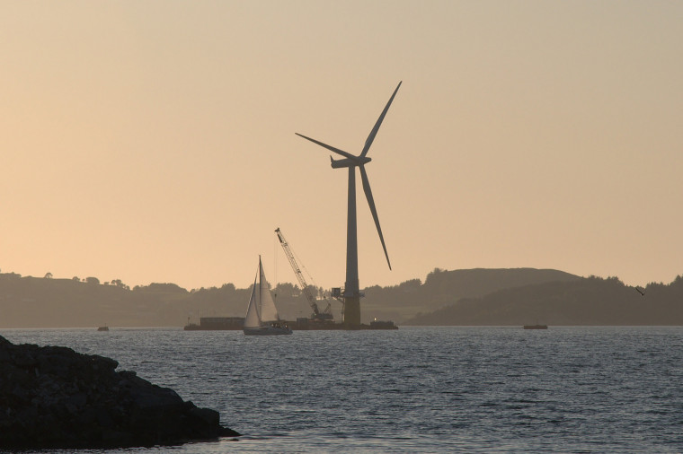 The world's first full-scale floating wind turbine, the 2.3 MW Hywind, being assembled in the Åmøy Fjord near Stavanger, Norway in 2009...