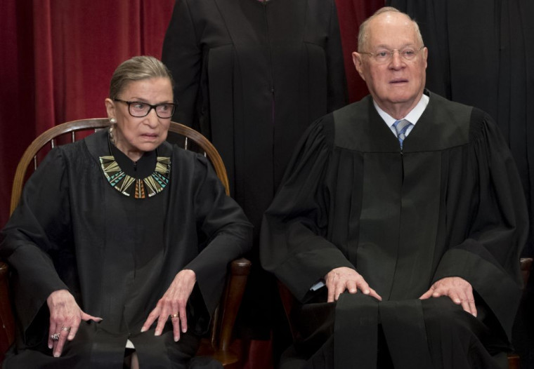 US Supreme Court Associate Justice Anthony M. Kennedy (R) and Associate Justice Ruth Bader Ginsburg (L) sit for an official photo with ot...