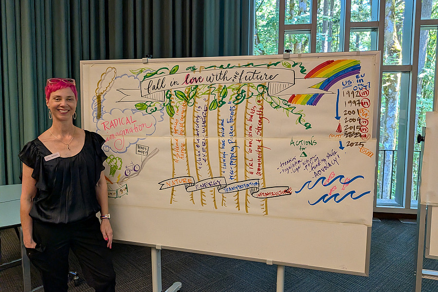 Artist Molly Chidsey stands beside Fall in Love with the Future, a live visual illustration capturing participants' collective visions fo...