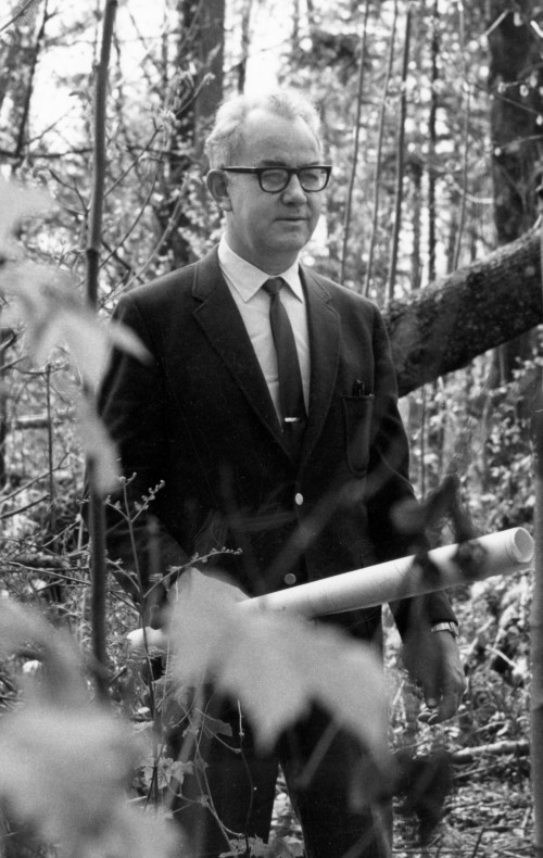 Interim Dean Jack Cairns, blueprints in hand, walks the site of the future law campus in 1968.