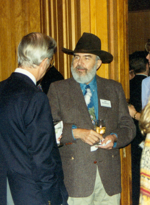 Professor Bill Williamson chats at a reception in the 1990s.