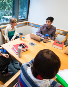 Students discuss around a table