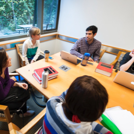 Students discuss around a table
