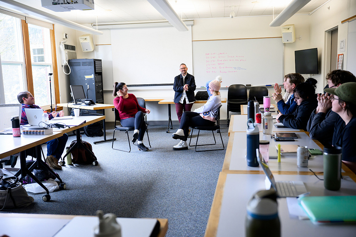 Graduate students enrolled in the counseling program practice being therapist and client in class.