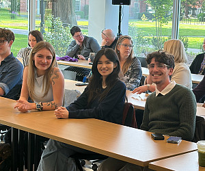 Three students sit at a table.