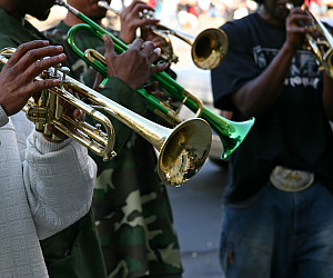 Close up of a person playing a trumpet.
