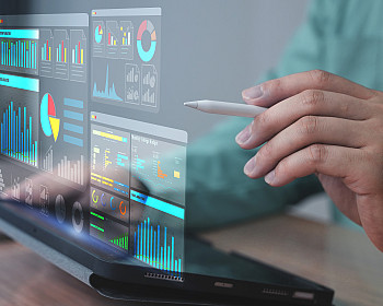 Projected digital interface showing business analytics, charts, and data dashboards.