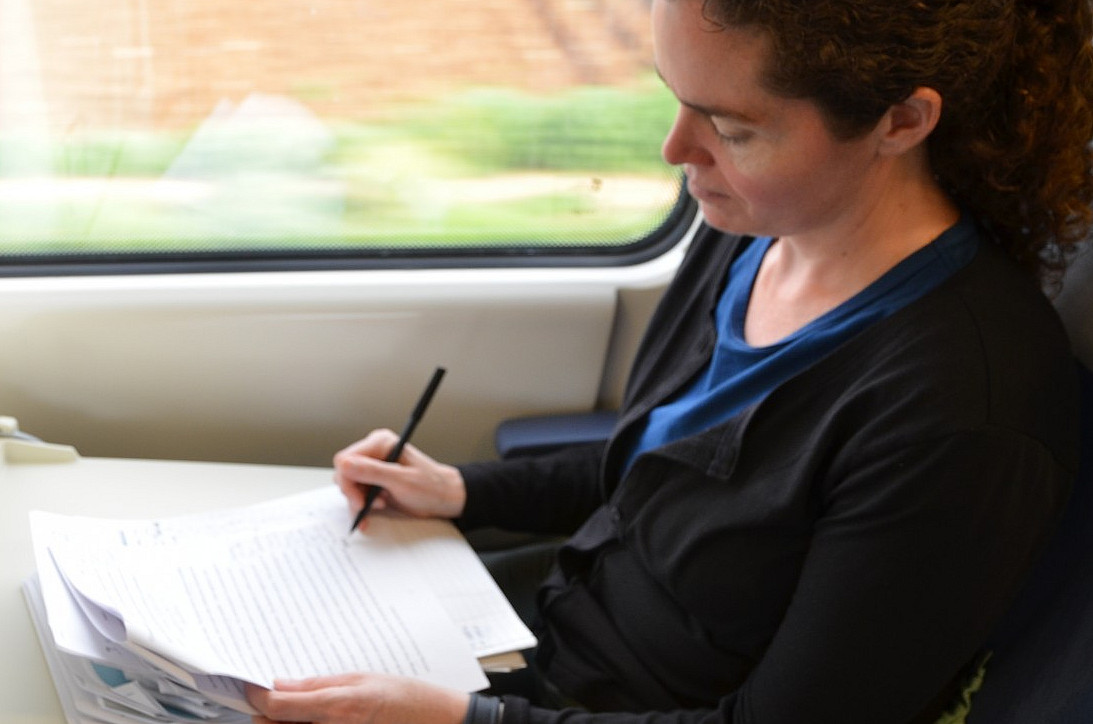 Professor Powers: grading papers on train in Spain