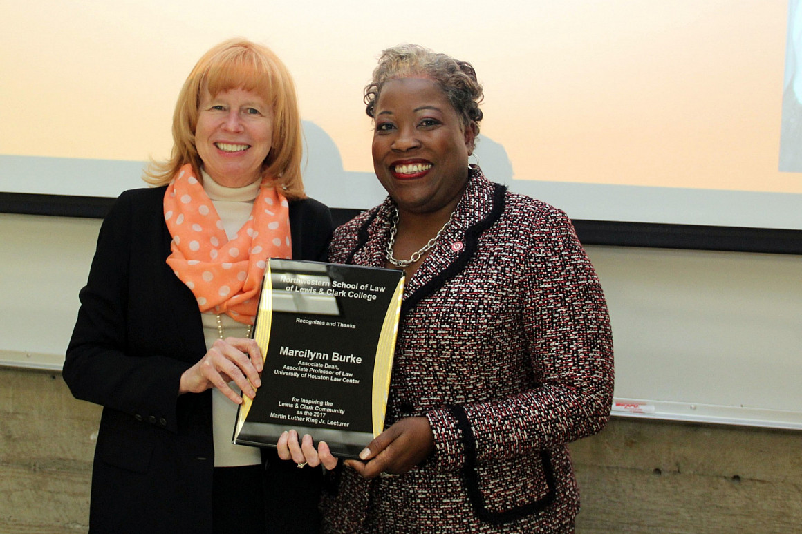 Marcilynn Burke receives plaque from Law School Dean Jennifer Johnson for her contributions.