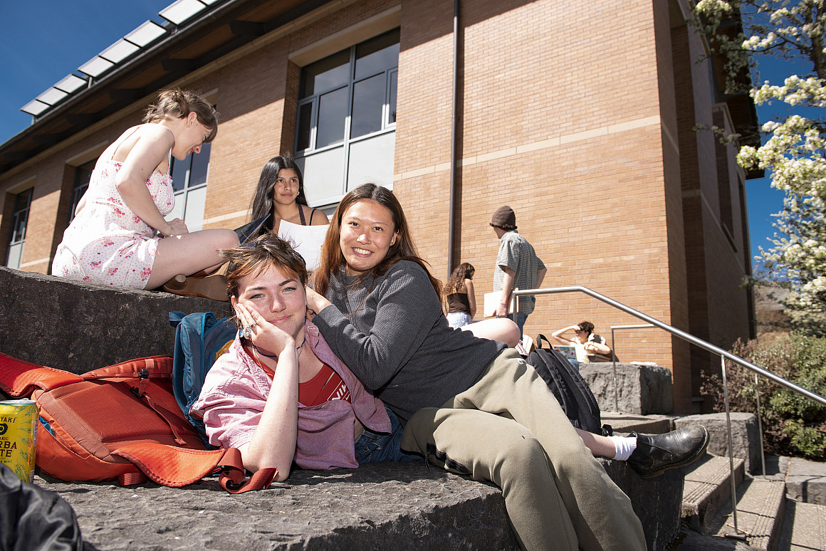 Students lounge outside on campus.