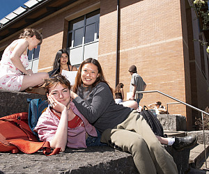 Students lounge outside on campus.